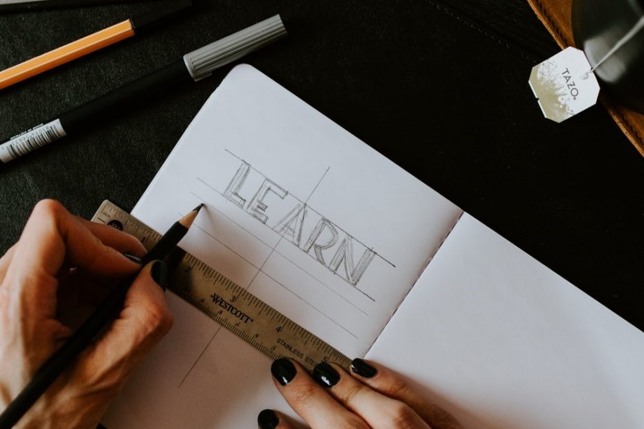 A Pair of Hands Drawing Straight Lines on A Page Labeled “Learn”